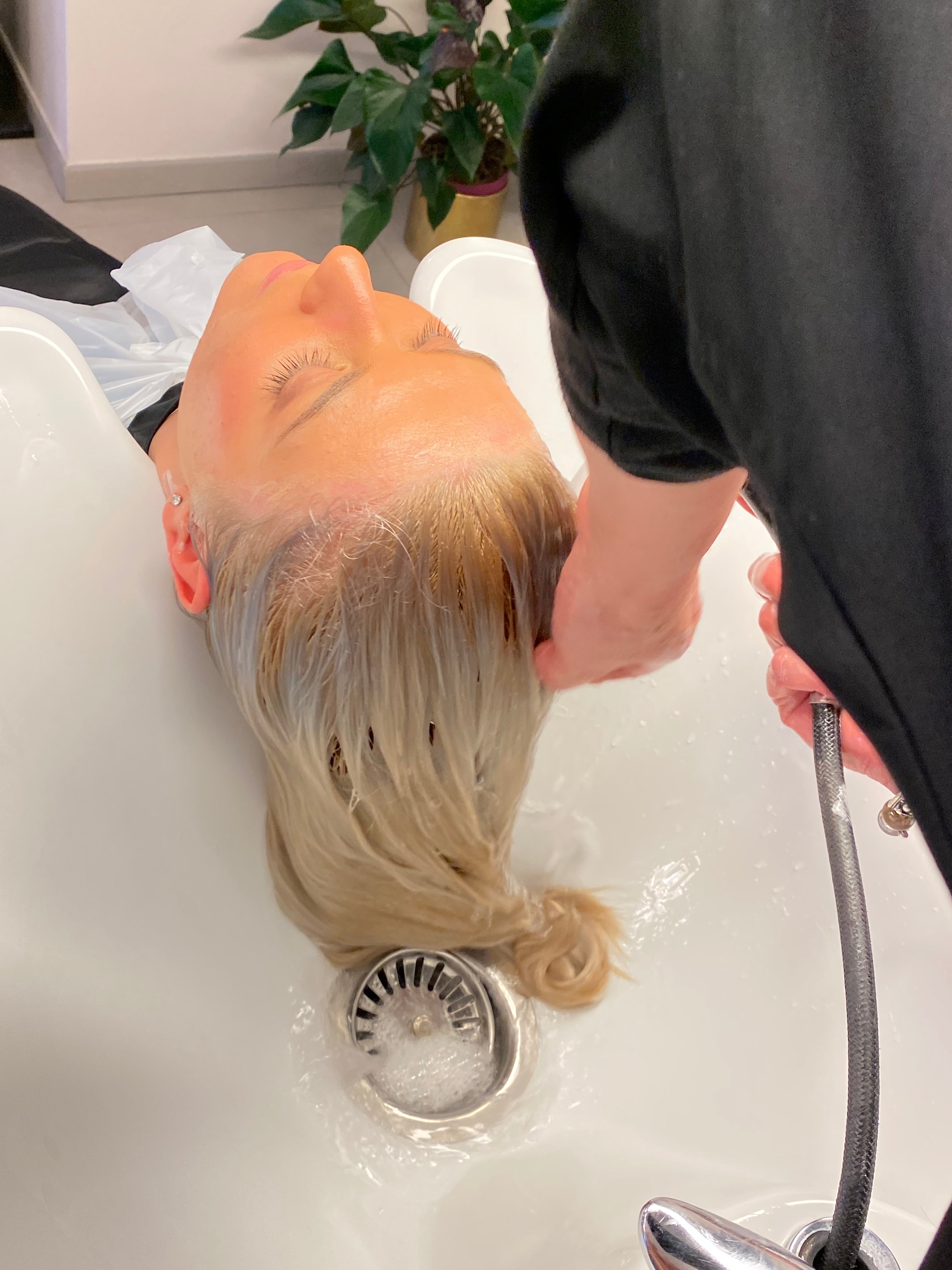 ragazza con i capelli biondi al lavaggio nel salone MCH studio